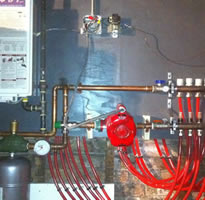Wall hung gas boiler with radiant manifolds 